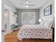Cozy bedroom boasting wood floors, a ceiling fan, and natural light from the windows at 212 W Powhatan Ave, Tampa, FL 33604