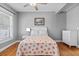 Bright bedroom featuring wood floors, a ceiling fan, and light gray walls at 212 W Powhatan Ave, Tampa, FL 33604
