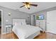 Comfortable bedroom with hardwood floors, a ceiling fan, and neutral wall color at 212 W Powhatan Ave, Tampa, FL 33604