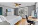 Bright bedroom boasts ample natural light, hardwood floors, and a comfortable workspace at 212 W Powhatan Ave, Tampa, FL 33604