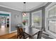 View of a dining area with hardwood floors, neutral walls, and a view to the kitchen with stainless appliances at 212 W Powhatan Ave, Tampa, FL 33604