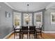 View of a dining area with hardwood floors, neutral walls, natural lighting and pendant lighting above the dining table at 212 W Powhatan Ave, Tampa, FL 33604