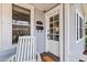 Charming entrance with rocking chair and detailed front door at 212 W Powhatan Ave, Tampa, FL 33604