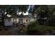 Exterior view of a charming home with a covered porch, landscaping, and a beautiful yard at 212 W Powhatan Ave, Tampa, FL 33604