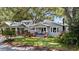 Charming bungalow-style home with a welcoming front porch, lush landscaping and classic architecture at 212 W Powhatan Ave, Tampa, FL 33604