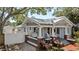 Charming craftsman home featuring a quaint front porch with swing and brick accents at 212 W Powhatan Ave, Tampa, FL 33604