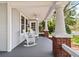 Charming front porch with rocking chairs and brick support columns at 212 W Powhatan Ave, Tampa, FL 33604