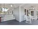 Inviting front porch with swing, rocking chairs, and white columns at 212 W Powhatan Ave, Tampa, FL 33604