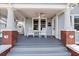 Charming covered porch with columns and rocking chairs at 212 W Powhatan Ave, Tampa, FL 33604