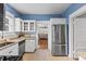 The kitchen has white cabinets, stainless steel appliances, and granite countertops at 212 W Powhatan Ave, Tampa, FL 33604