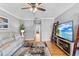 Relaxing living room featuring hardwood floors, a ceiling fan, and a neutral color palette at 212 W Powhatan Ave, Tampa, FL 33604
