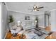 The living room includes hardwood floors, a ceiling fan, and comfortable seating at 212 W Powhatan Ave, Tampa, FL 33604