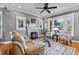Bright living room featuring a fireplace, hardwood floors, and ample windows at 212 W Powhatan Ave, Tampa, FL 33604