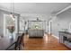 View of an open living room and dining area with hardwood floors and lots of natural light from surrounding windows at 212 W Powhatan Ave, Tampa, FL 33604