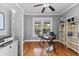 View of an office space with hardwood floors, neutral walls, ceiling fan, natural light, and office furniture at 212 W Powhatan Ave, Tampa, FL 33604