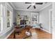 Well-lit office with hardwood floors, neutral walls, a ceiling fan and lots of natural light from the surrounding windows at 212 W Powhatan Ave, Tampa, FL 33604