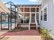 Inviting screened-in patio provides seamless indoor-outdoor living with a view of the pool at 212 W Powhatan Ave, Tampa, FL 33604
