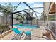 Beautiful backyard pool with screened enclosure and comfortable lounge chairs for ultimate relaxation at 212 W Powhatan Ave, Tampa, FL 33604