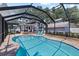 Screened-in pool area features a private pool and inviting patio with lounge chairs, perfect for relaxation at 212 W Powhatan Ave, Tampa, FL 33604