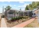 Landscaped pool area with a screened-in pool and patio offers a serene outdoor retreat at 212 W Powhatan Ave, Tampa, FL 33604