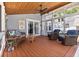 Relaxing screened porch with wood ceiling, comfortable seating, and views of the outdoors at 212 W Powhatan Ave, Tampa, FL 33604