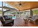 Charming outdoor porch offering comfortable seating and a view of the sparkling pool area at 212 W Powhatan Ave, Tampa, FL 33604