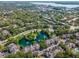 Gorgeous aerial view of homes nestled amongst lush greenery, centered around a picturesque pond and fountain at 2173 Tuscany Trce # 8, Palm Harbor, FL 34683