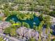 Beautiful aerial view overlooking condos surrounded by a nature filled landscape with a serene pond and water feature at 2173 Tuscany Trce # 8, Palm Harbor, FL 34683