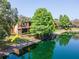 Beautiful backyard with direct lake access and lush tropical landscaping at 2173 Tuscany Trce # 8, Palm Harbor, FL 34683