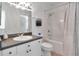 Bright bathroom featuring a shower-tub combo, white cabinetry, and neutral countertop at 2173 Tuscany Trce # 8, Palm Harbor, FL 34683