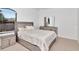 Well-lit bedroom featuring a full bed, dresser, and large window at 2173 Tuscany Trce # 8, Palm Harbor, FL 34683
