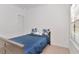 Bedroom featuring a bed with blue linens, closet, and ample natural light at 2173 Tuscany Trce # 8, Palm Harbor, FL 34683