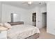 Spacious bedroom with full bed, dresser, and a glimpse into an en-suite bathroom at 2173 Tuscany Trce # 8, Palm Harbor, FL 34683