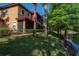 Exterior view of a multi-story home with a screened porch, backing onto a serene pond at 2173 Tuscany Trce # 8, Palm Harbor, FL 34683