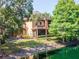 Exterior of the home with lush landscaping, mature trees and pond at 2173 Tuscany Trce # 8, Palm Harbor, FL 34683