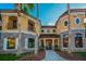 Stunning two-story home with a stone and stucco facade, arched windows, and lush landscaping at 2173 Tuscany Trce # 8, Palm Harbor, FL 34683