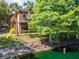 Exterior of home with lush landscape, trees, and pond at 2173 Tuscany Trce # 8, Palm Harbor, FL 34683