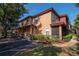A two-story apartment featuring a red roof, tan exterior, and a screened in patio at 2173 Tuscany Trce # 8, Palm Harbor, FL 34683