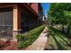 Condos with screened patios and landscaped hedges along a sidewalk by the lake at 2173 Tuscany Trce # 8, Palm Harbor, FL 34683