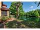 Lakeside condo complex with manicured lawn and screened patios at 2173 Tuscany Trce # 8, Palm Harbor, FL 34683