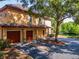 Charming townhome with two-car garage, manicured landscaping, and mature shade trees at 2173 Tuscany Trce # 8, Palm Harbor, FL 34683