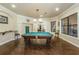 Bright game room featuring a pool table, hardwood floors, and stylish decor with natural light at 2173 Tuscany Trce # 8, Palm Harbor, FL 34683