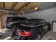 Spacious garage with two parked cars and an automatic door opener at 2173 Tuscany Trce # 8, Palm Harbor, FL 34683
