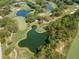 Picturesque aerial view of a meticulously maintained golf course featuring lush green fairways, serene water hazards, and tree-lined landscape at 2173 Tuscany Trce # 8, Palm Harbor, FL 34683