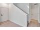 Hallway with carpet floor leading to stairway with white doors on each side at 2173 Tuscany Trce # 8, Palm Harbor, FL 34683