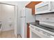 Efficient kitchen featuring stainless steel appliances and ample cabinet space, plus laundry area at 2173 Tuscany Trce # 8, Palm Harbor, FL 34683
