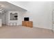Bright living room featuring plush carpeting, modern light fixture, and open access to the kitchen at 2173 Tuscany Trce # 8, Palm Harbor, FL 34683