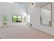 Bright living room features neutral carpet, large windows, and a modern light fixture at 2173 Tuscany Trce # 8, Palm Harbor, FL 34683