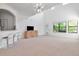 Bright living room featuring plush carpeting, modern light fixture, and open access to the kitchen at 2173 Tuscany Trce # 8, Palm Harbor, FL 34683