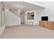 Bright living room featuring plush carpeting, staircase to the second floor, and open access to the kitchen at 2173 Tuscany Trce # 8, Palm Harbor, FL 34683